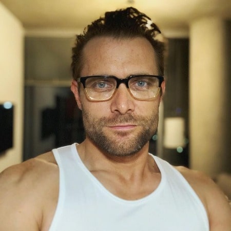 Neil Hopkins looks handsome in his white t-shirt with a nice glasses.